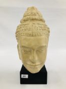 A LARGE CARVED STONE BUDDHA BUST ON A SQUARE BASE.