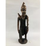 A LARGE ETHNIC HARDWOOD CARVING OF A KNEELING HUNTSMAN - H 69CM.