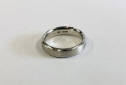 A HEAVY WEDDING BAND MARKED 950 PLATINUM, MATT FINISH.