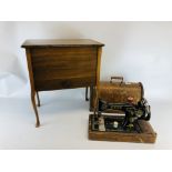 A VINTAGE SINGER SEWING MACHINE IN FITTED CASE ALONG WITH A SILK LINED SEWING BOX ON SPLAYED LEGS.