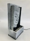 A RESIN LIGHT UP WATER FEATURE DEPICTING BUDDHA HEAD, W 27CM X H 48CM - SOLD AS SEEN.