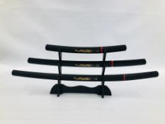 A SET OF 3 REPRODUCTION DISPLAY SAMURAI SWORDS IN SHEATH'S COMPLETE WITH BRACKET.