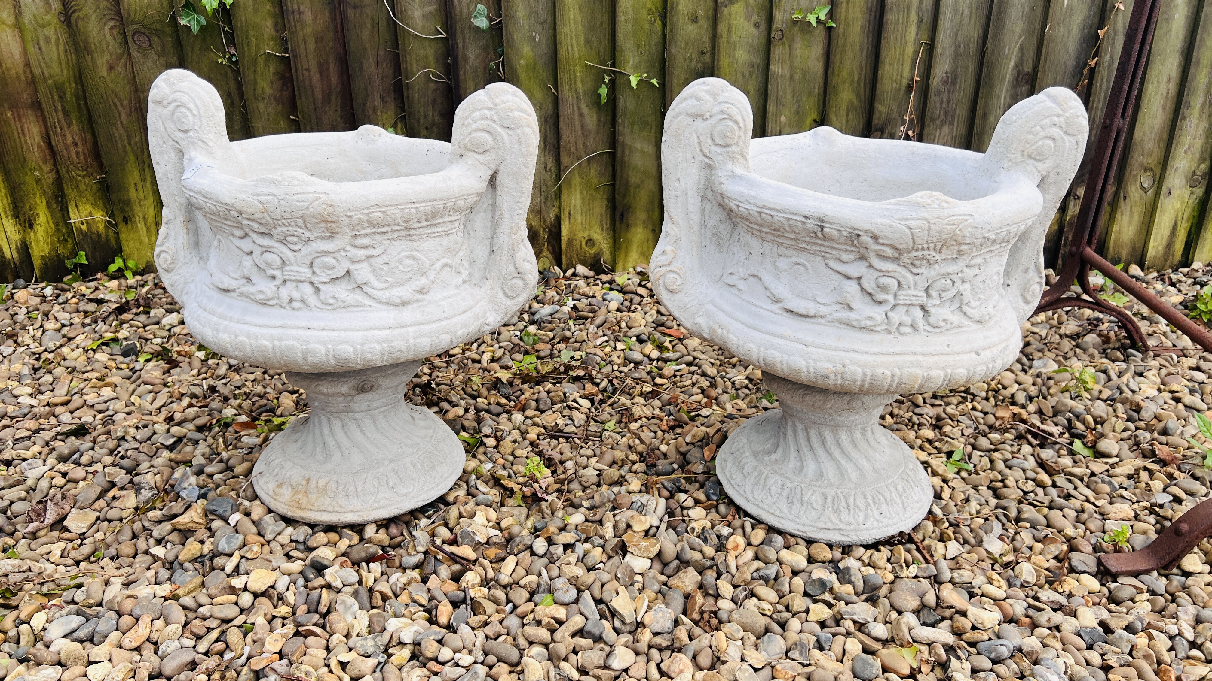 A PAIR OF CLASSICAL DESIGN TWIN HANDLED STONEWORK PEDESTAL GARDEN URN PLANTERS, HEIGHT 45CM,