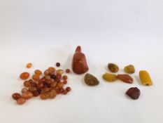 A BAG OF ASSORTED RAW AND POLISHED AMBER TYPE SAMPLES AND BEADS.