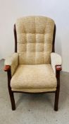 AN OATMEAL UPHOLSTERED ARM CHAIR.