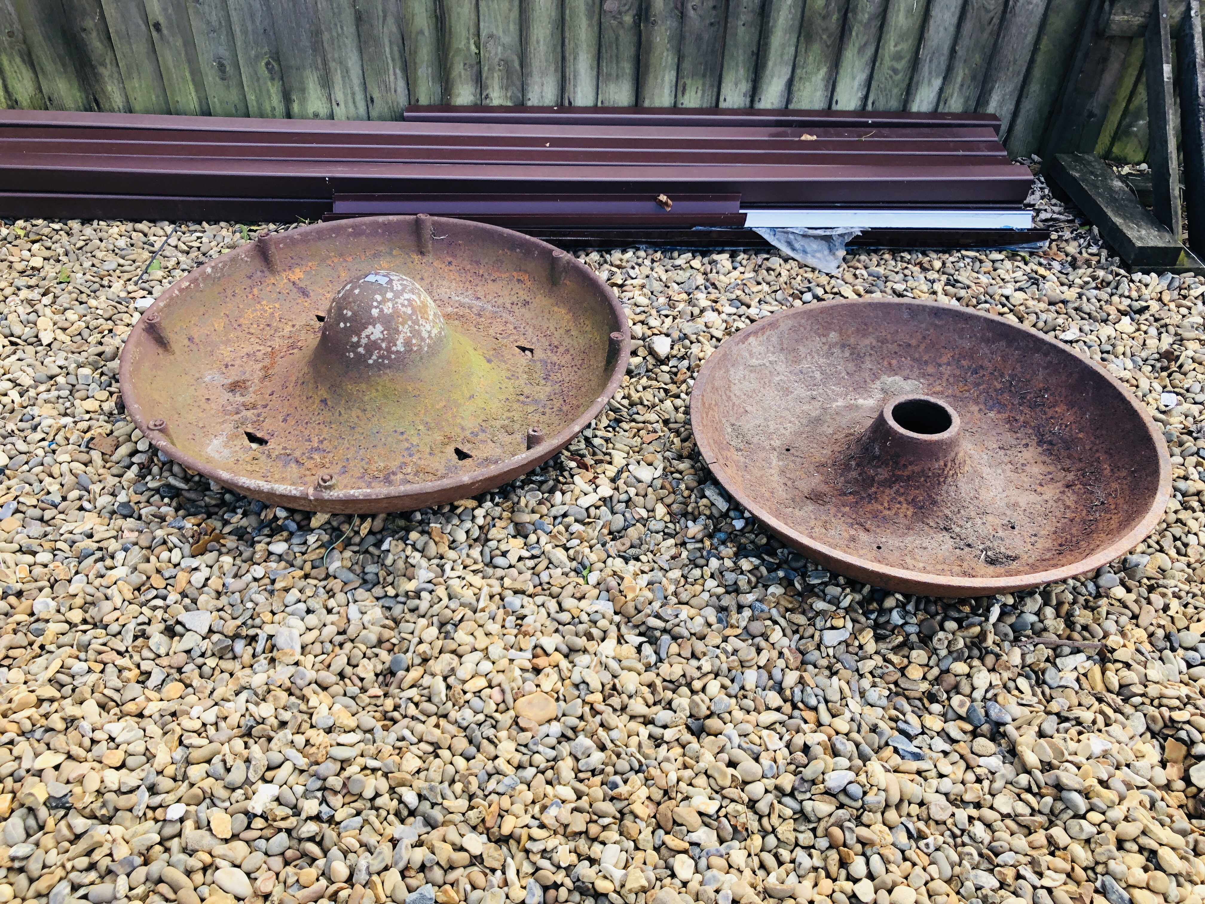 TWO VINTAGE CAST IRON MEXICAN HAT PIG FEEDERS / PLANTERS, LARGEST 90CM DIAMETER, A/F.