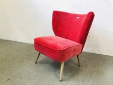 A MODERN DESIGNER PINK VELOUR UPHOLSTERED LOW BEDROOM CHAIR (TRADE ONLY)