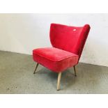 A MODERN DESIGNER PINK VELOUR UPHOLSTERED LOW BEDROOM CHAIR (TRADE ONLY)