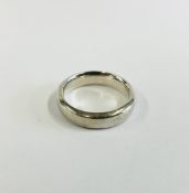 A WHITE METAL WEDDING BAND.