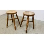 A PAIR OF VINTAGE SOLID BEECH STOOLS - HEIGHT 50CM.