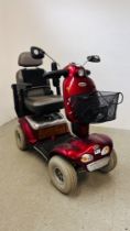 A SHOPRIDER DELUXE MOBILITY SCOOTER AND CHARGER (KEY WITH AUCTIONEER) - SOLD AS SEEN.