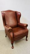 A GOOD QUALITY TAN LEATHER WING BACK CHAIR.