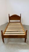 A MODERN HONEY PINE SINGLE BEDFRAME.