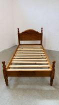 A MODERN HONEY PINE SINGLE BEDFRAME.