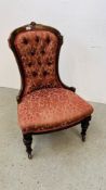 A VICTORIAN MAHOGANY FRAMED NURSING CHAIR WITH RED FLORAL UPHOLSTERY.