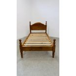 A MODERN HONEY PINE SINGLE BEDFRAME.