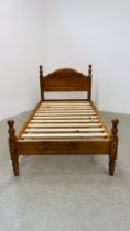 A MODERN HONEY PINE SINGLE BEDFRAME.