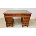 A REPRODUCTION SEVEN DRAWER KNEEHOLE DESK WITH TOOLED LEATHER TOP