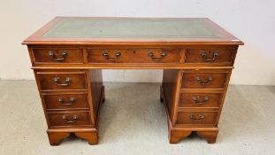 A REPRODUCTION SEVEN DRAWER KNEEHOLE DESK WITH TOOLED LEATHER TOP