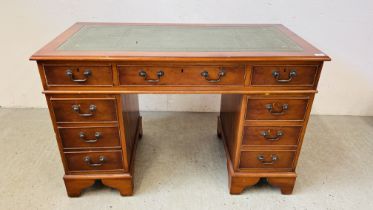 A REPRODUCTION SEVEN DRAWER KNEEHOLE DESK WITH TOOLED LEATHER TOP