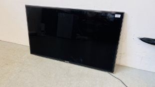 A SAMSUNG 40" FLAT SCREEN SMART TV WITH REMOTE - SOLD AS SEEN.