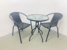 A GLASS TOPPED CIRCULAR GARDEN TABLE ALONG WITH TWO MATCHING METAL AND RATTAN STYLE CHAIRS,