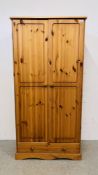 MODERN HONEY PINE TWO DOOR WARDROBE WITH SINGLE DRAWER TO BASE.