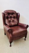 A GOOD QUALITY TAN LEATHER BUTTON BACK WING CHAIR.