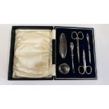 A CASED SILVER MANICURE SET MARKED G & CLO BIRMINGHAM ASSAY.