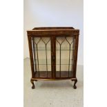 A 1940'S OAK CASED BOW FRONT DISPLAY CABINET.