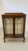 A 1940'S OAK CASED BOW FRONT DISPLAY CABINET.