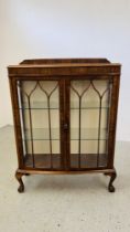 A 1940'S OAK CASED BOW FRONT DISPLAY CABINET.