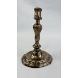 A CONTINENTAL CAST SILVER CANDLESTICK, THE GADROONED COLUMN ON A STEPPED AND SCROLLED BASE - 21.