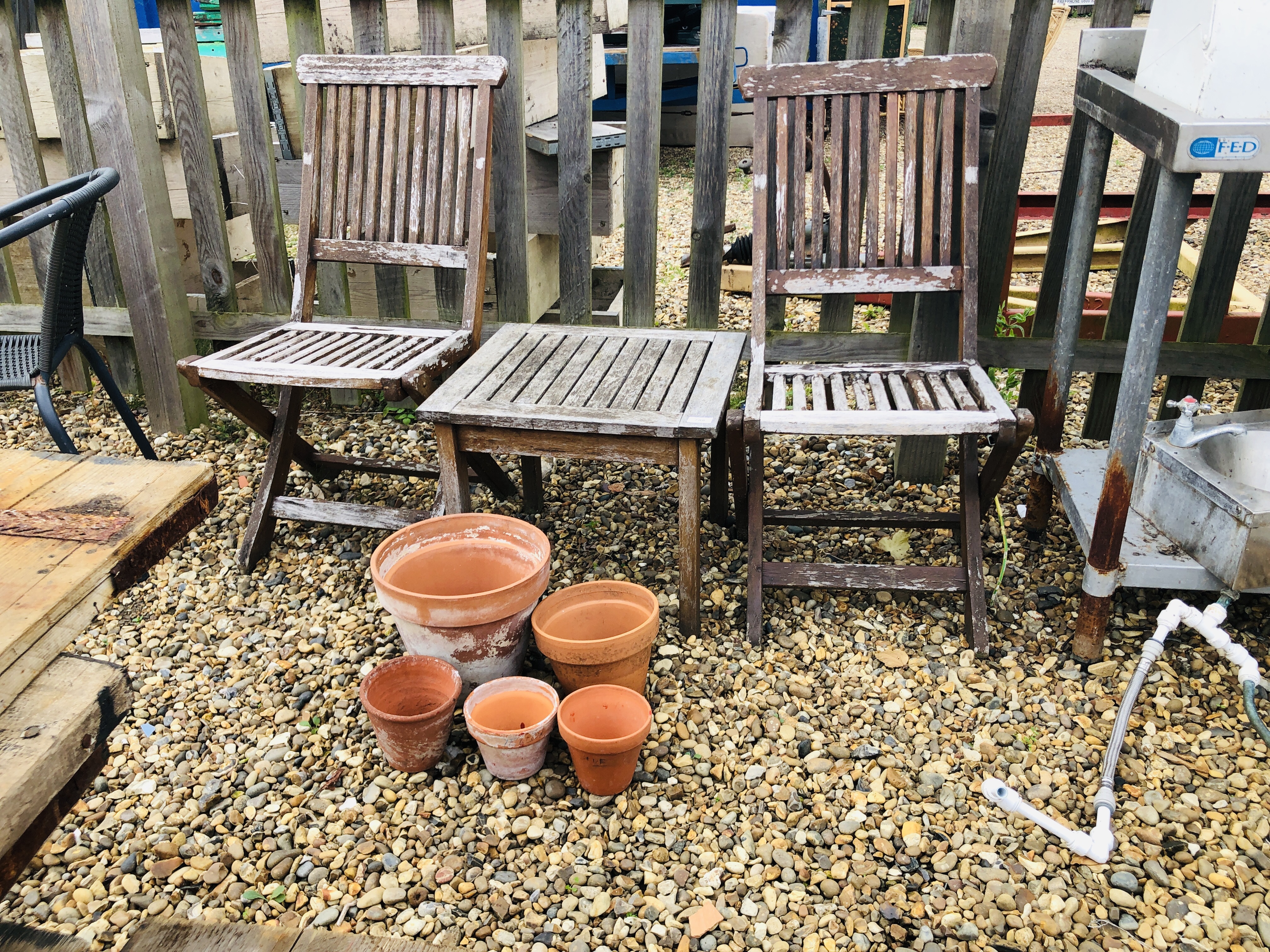 TWO FOLDING HARDWOOD GARDEN CHAIRS AND HARDWOOD DRINKS TABLE.