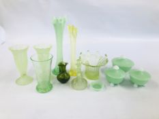 A GROUP OF GREEN GLASS TO INCLUDE A GRADUATED SET OF LIDDED JARS ETC.