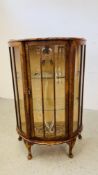 A 1940'S MAHOGANY BOW FRONT DISPLAY CABINET WITH SLIDING DOOR.