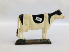 A VINTAGE CAST DOORSTOP IN THE FORM OF A COW.