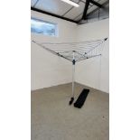 A FOLDING ROTARY WASHING LINE COMPLETE WITH EASY INSTALL STAKE.