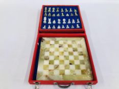 AN ONYX CHESS SET AND BOARD IN A FITTED CASE.