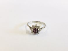 AN IMPRESSIVE UNMARKED WHITE GOLD FLOWER HEAD RING SET WITH MULTIPLE DIAMOND AND RUBIES (BAND CUT)