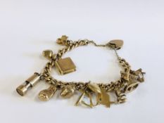 AN ANTIQUE 9CT. GOLD CHARM BRACELET AND PADLOCK CLASP CONTAINING 9 X 9CT. GOLD CHARMS, AN 18CT.