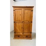 A WAXED PINE TWO DOOR WARDROBE WITH SINGLE DRAWER BASE - W 116CM X D 60CM X H 195CM.