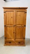 A WAXED PINE TWO DOOR WARDROBE WITH SINGLE DRAWER BASE - W 116CM X D 60CM X H 195CM.