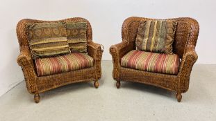 A PAIR OF MODERN WICKER CONSERVATORY ARMCHAIRS WITH UPHOLSTERED STRIPED SEAT CUSHIONS.