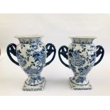 A PAIR OF 2 HANDLED FLORAL BLUE AND WHITE VASES 1 A/F (RIM CHIP).