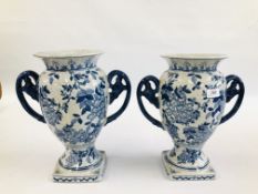 A PAIR OF 2 HANDLED FLORAL BLUE AND WHITE VASES 1 A/F (RIM CHIP).