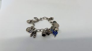 VINTAGE 925 SILVER GATE BRACELET WITH 11 CHARMS ATTACHED.