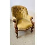 A VICTORIAN MAHOGANY FRAMED BUTTON BACK NURSING CHAIR ON CERAMIC CASTERS.