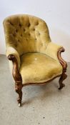 A VICTORIAN MAHOGANY FRAMED BUTTON BACK NURSING CHAIR ON CERAMIC CASTERS.