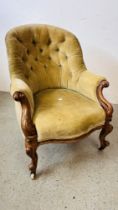 A VICTORIAN MAHOGANY FRAMED BUTTON BACK NURSING CHAIR ON CERAMIC CASTERS.